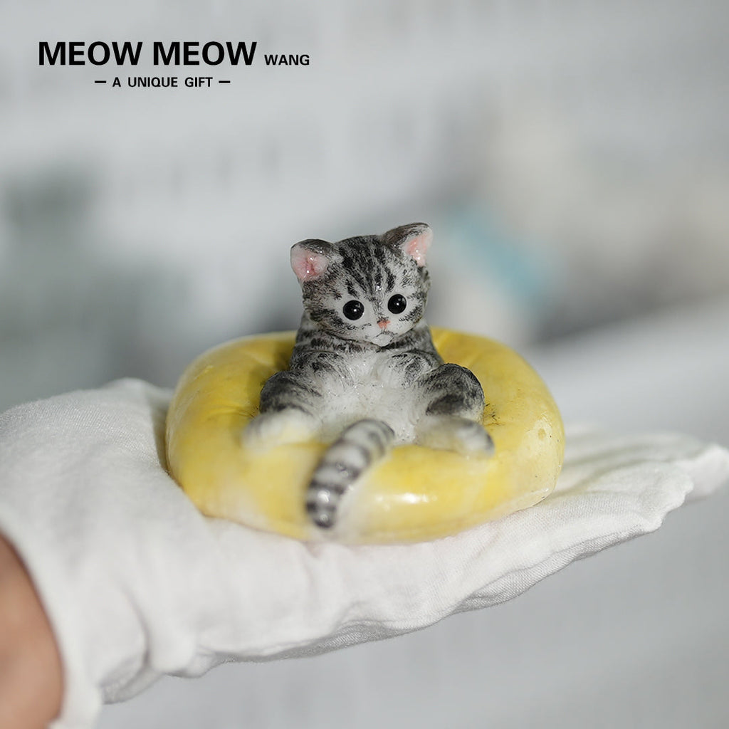 E03:Cute Little Kitten Sitting On A Pillow.